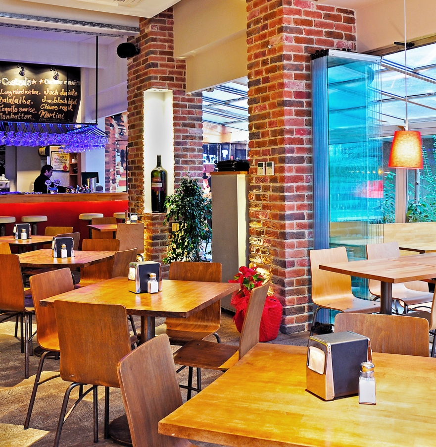 A light-well cafe with red brick walls