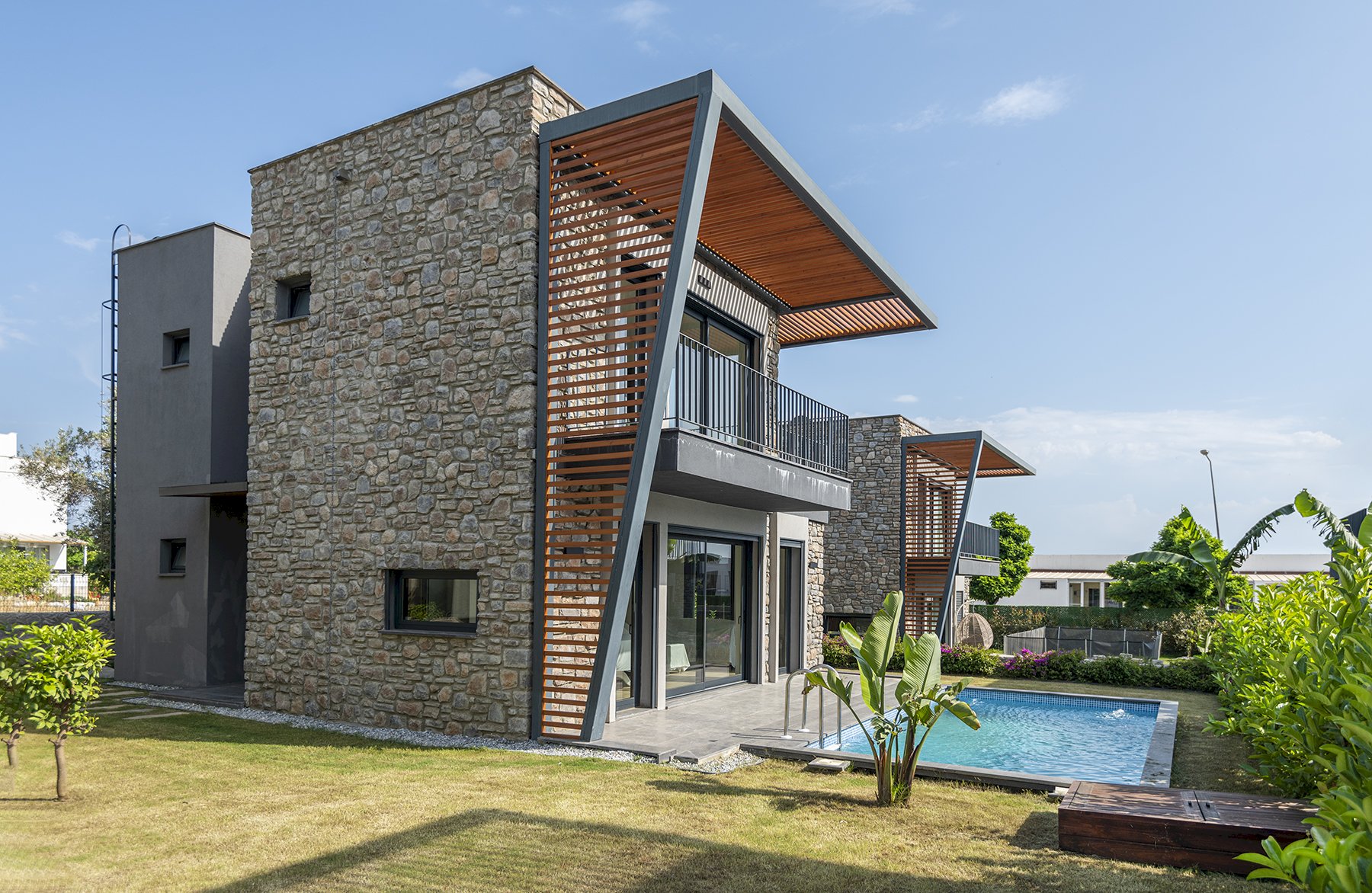 Villa with stone walls and wood soffits