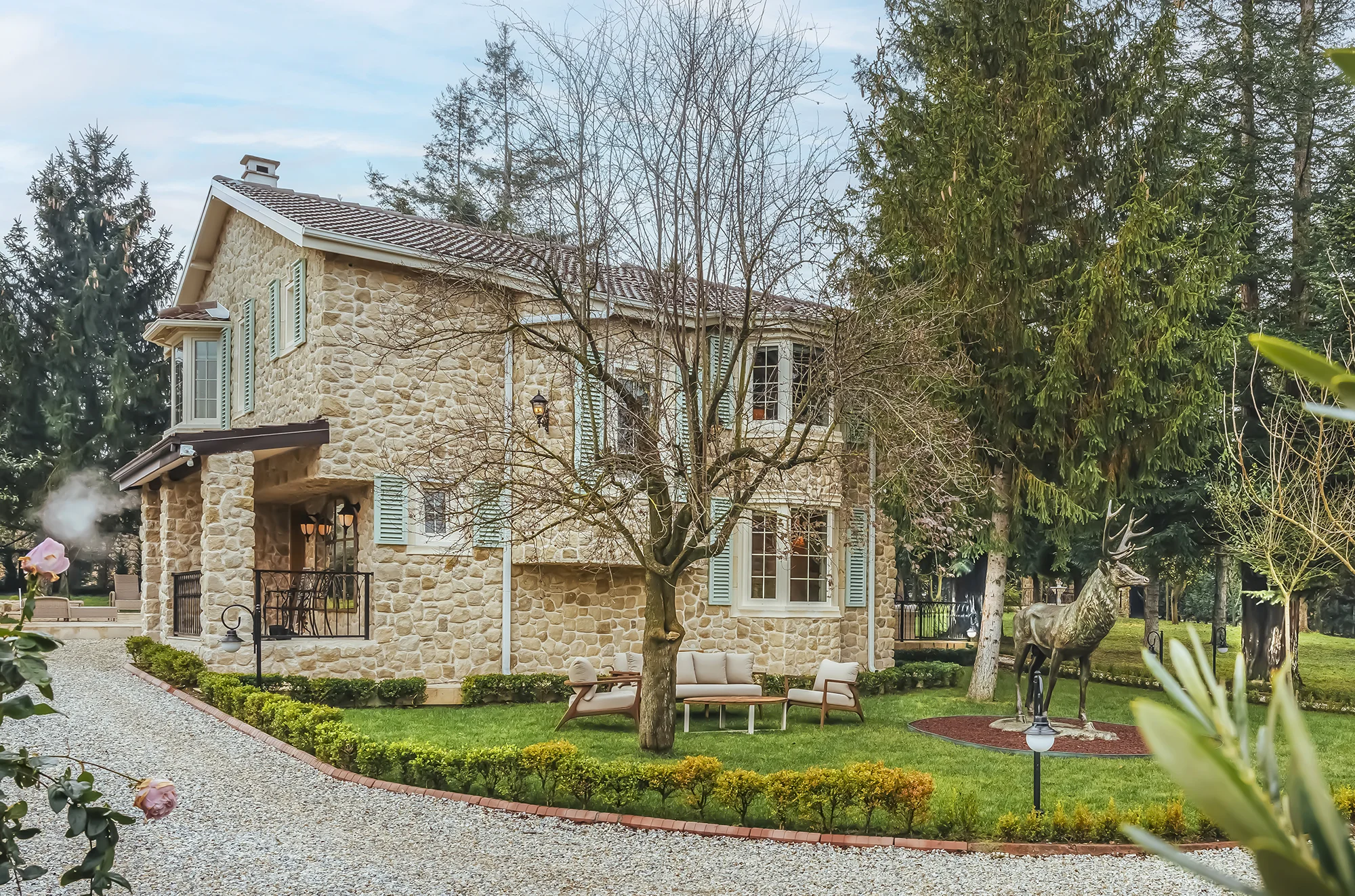 stone walls on a spectacular house in a green garden