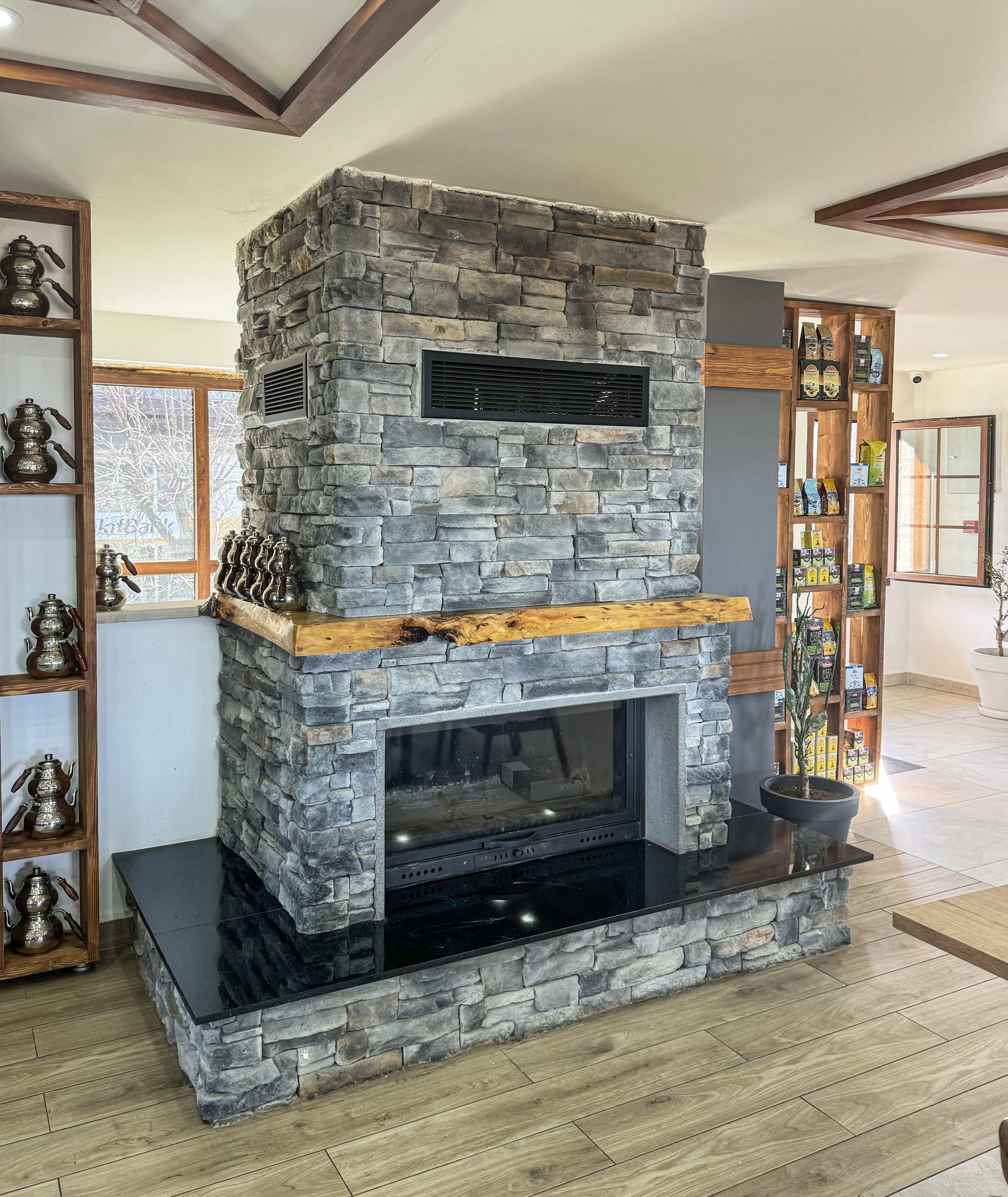 Fireplace with beautiful stone and hardwood flooring